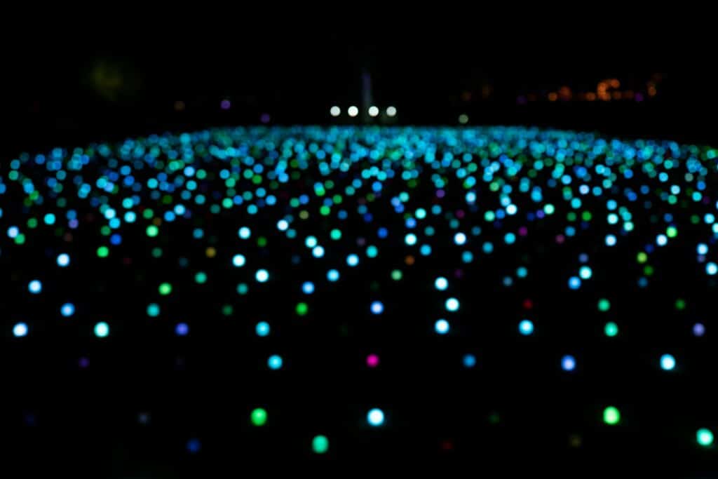 a field full of colorful lights in the dark