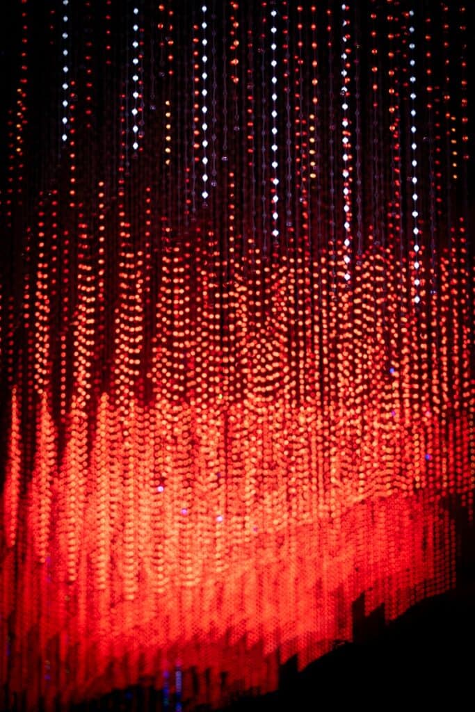 Red and white lights cascade downwards.