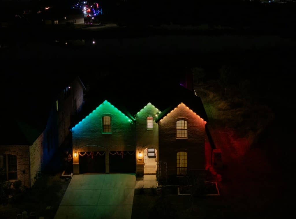 A couple of houses that are lit up at night