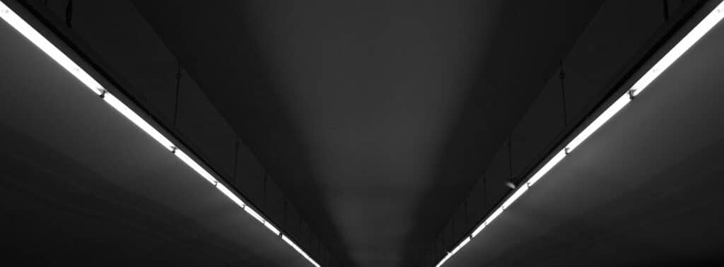 a black and white photo of a long hallway