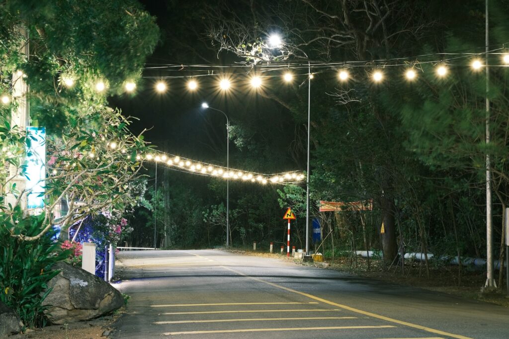 a street with lights strung over it at night