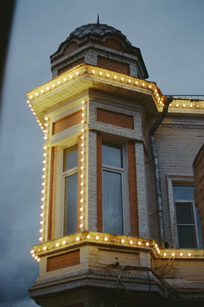 Building corner decorated with glowing string lights