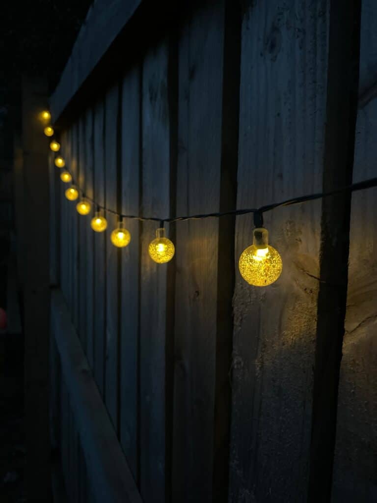 yellow string lights on brown wooden wall