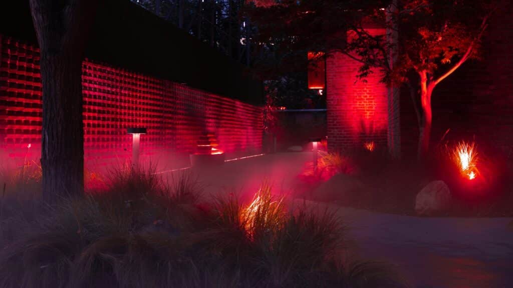 Red lights illuminate a night scene with fog.