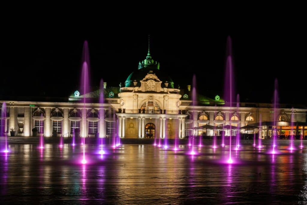 a large building with a fountain in front of it