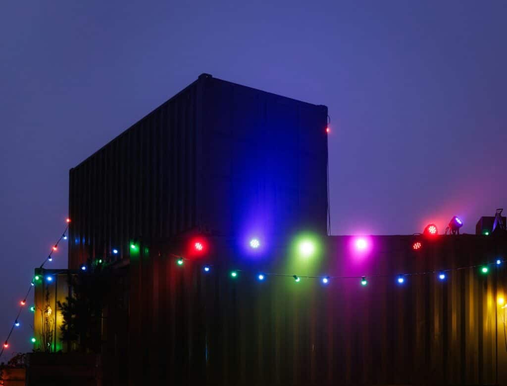 Building decorated with colorful string lights at dusk