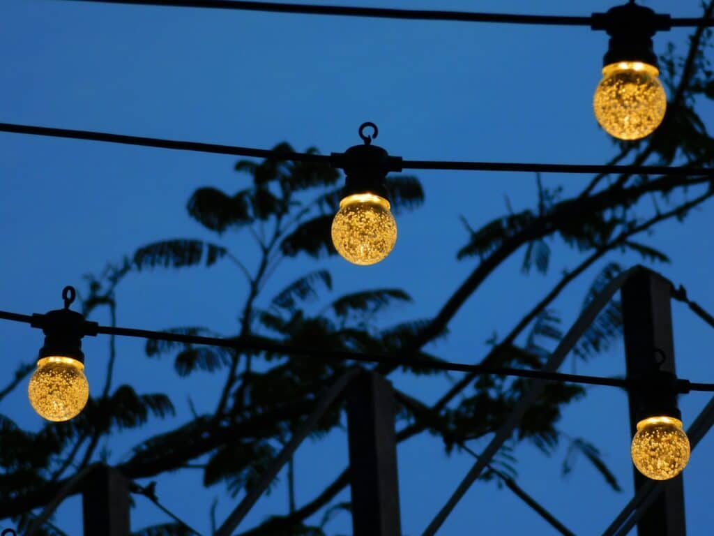 String lights glow against a twilight sky.