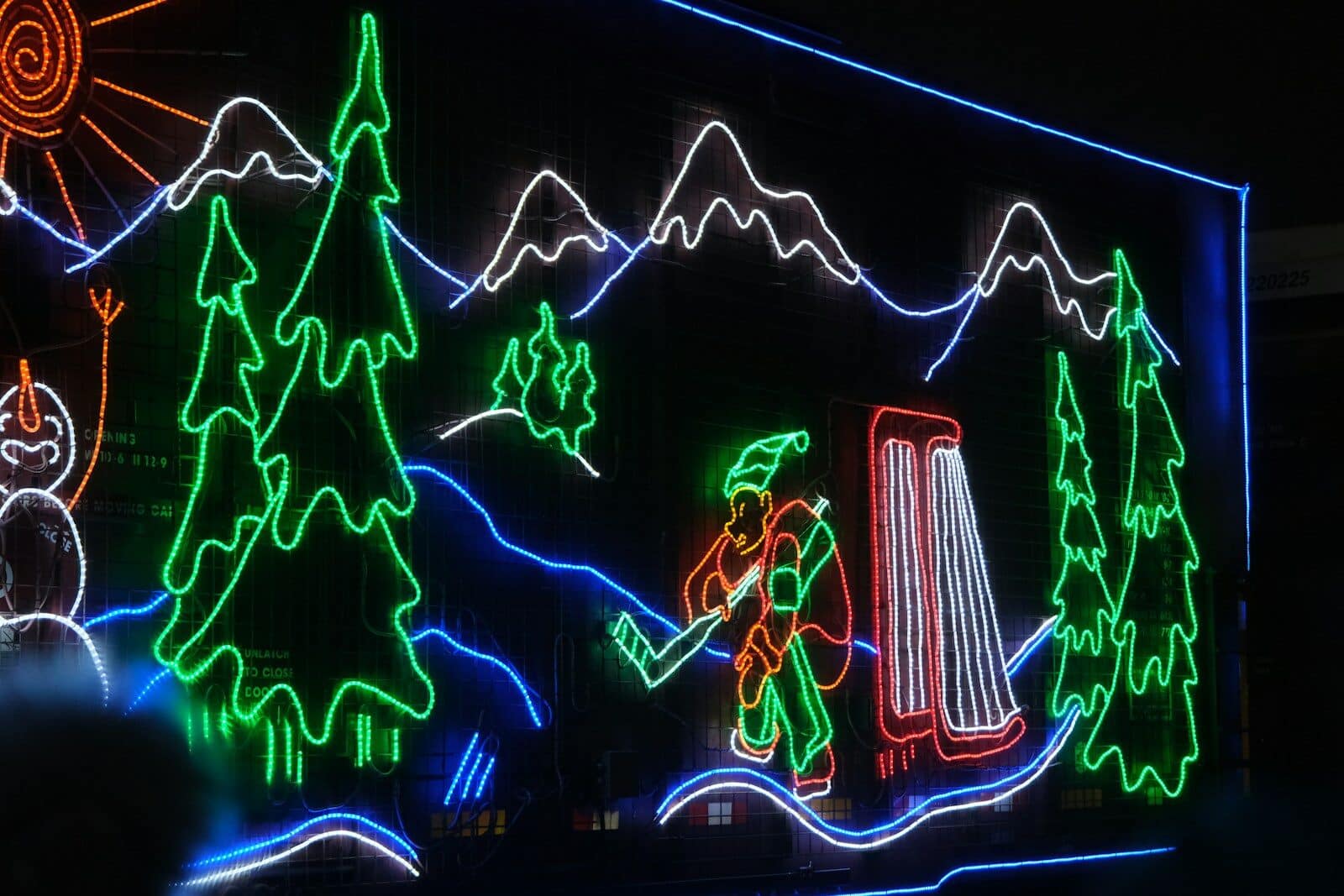 Neon lights depict a winter scene with hockey player.