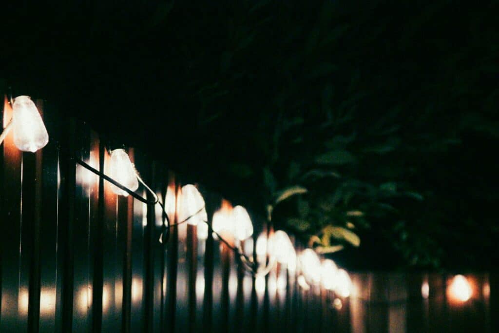A bunch of lights that are on a fence