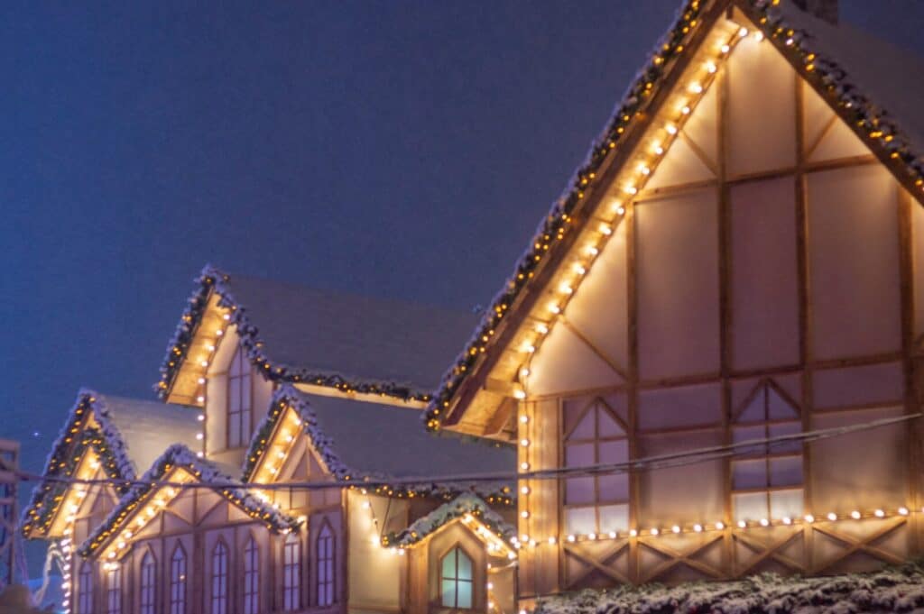 a row of houses covered in christmas lights