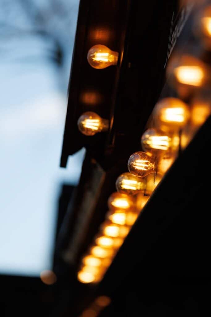Light bulbs illuminate a dark structure in a row.