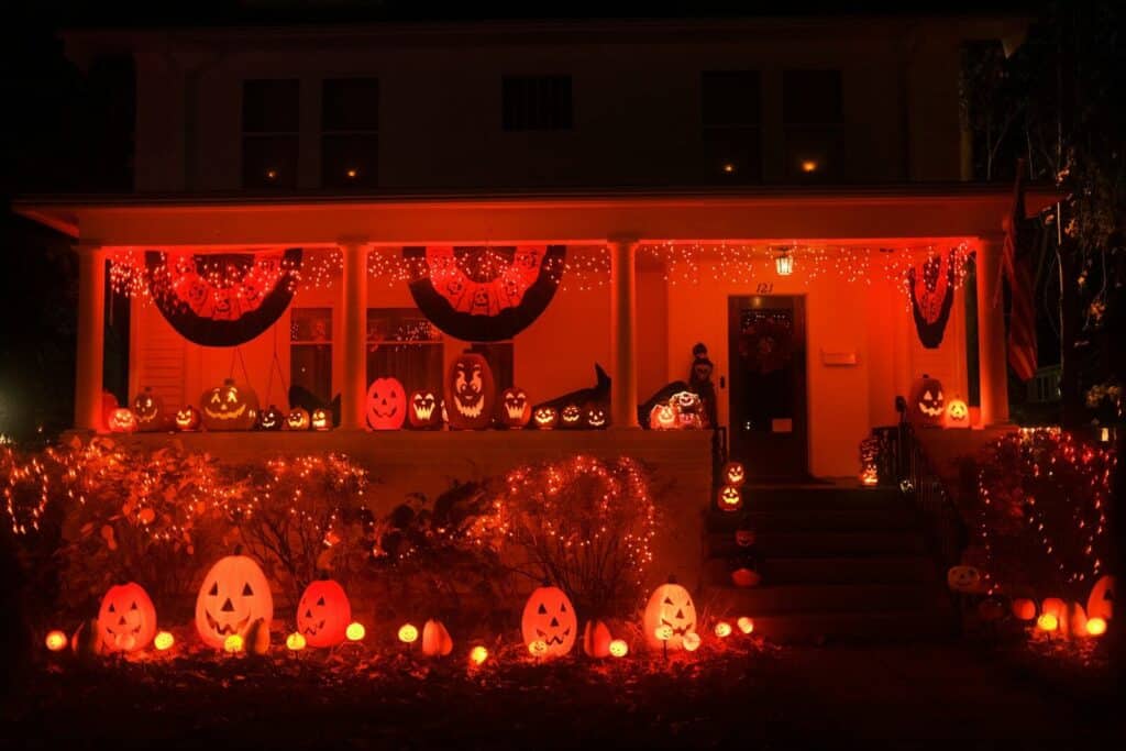 House decorated for halloween with orange lights and pumpkins